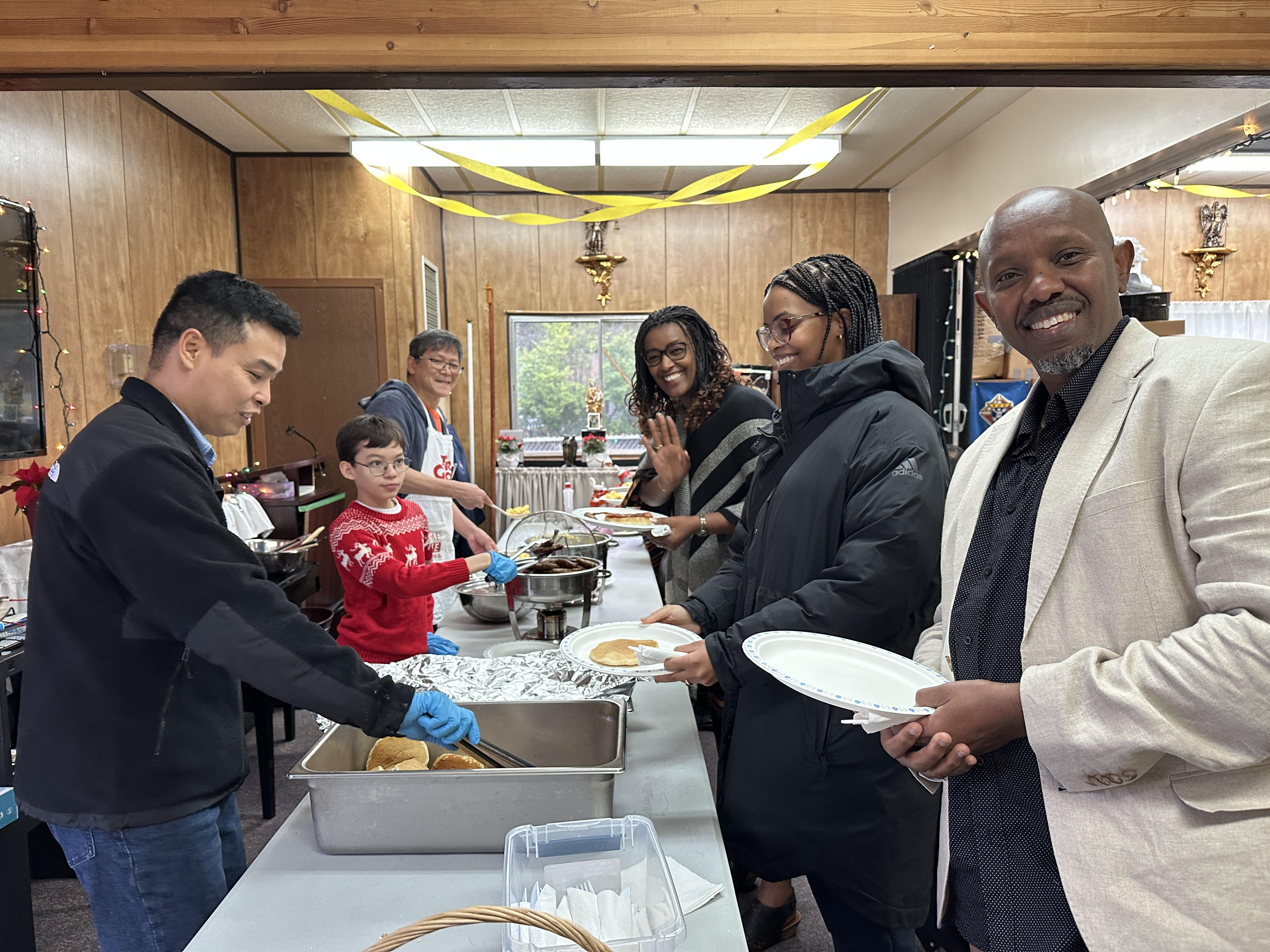 Guests receiving pancakes from the serving line