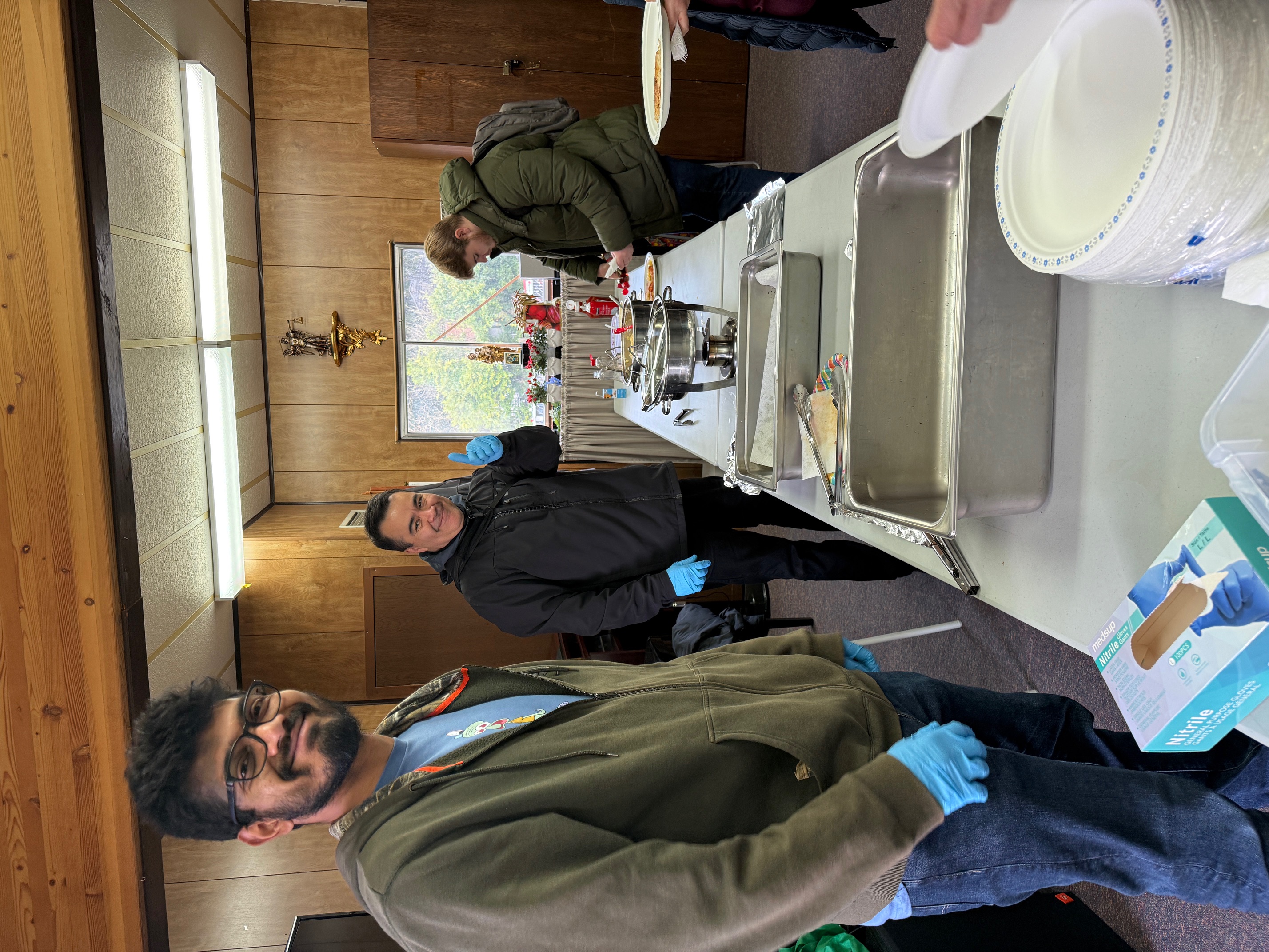 Knights volunteers preparing the serving area inside the portable
