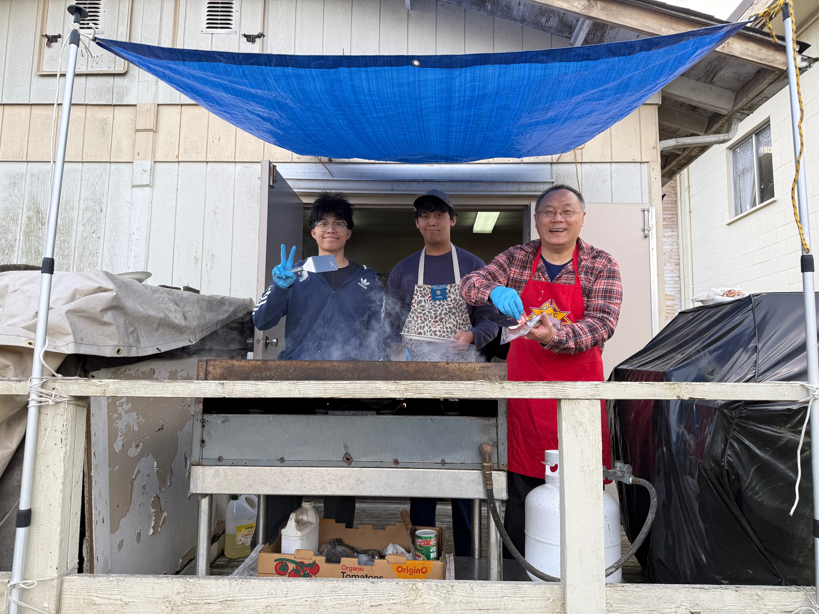 Knights volunteers cooking outside at the grill