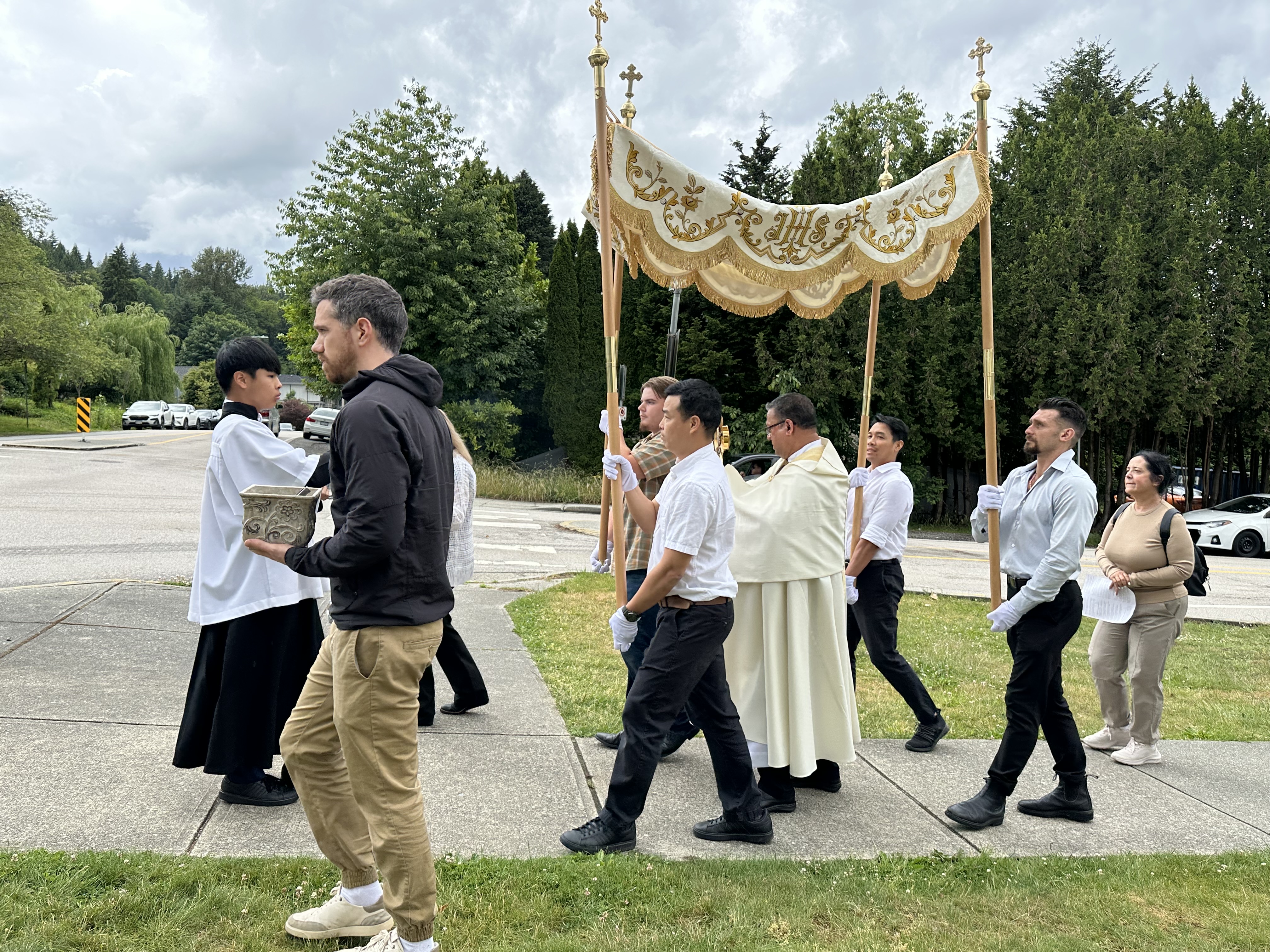 Close view of the priest and canopy bearers during the Corpus Christi procession