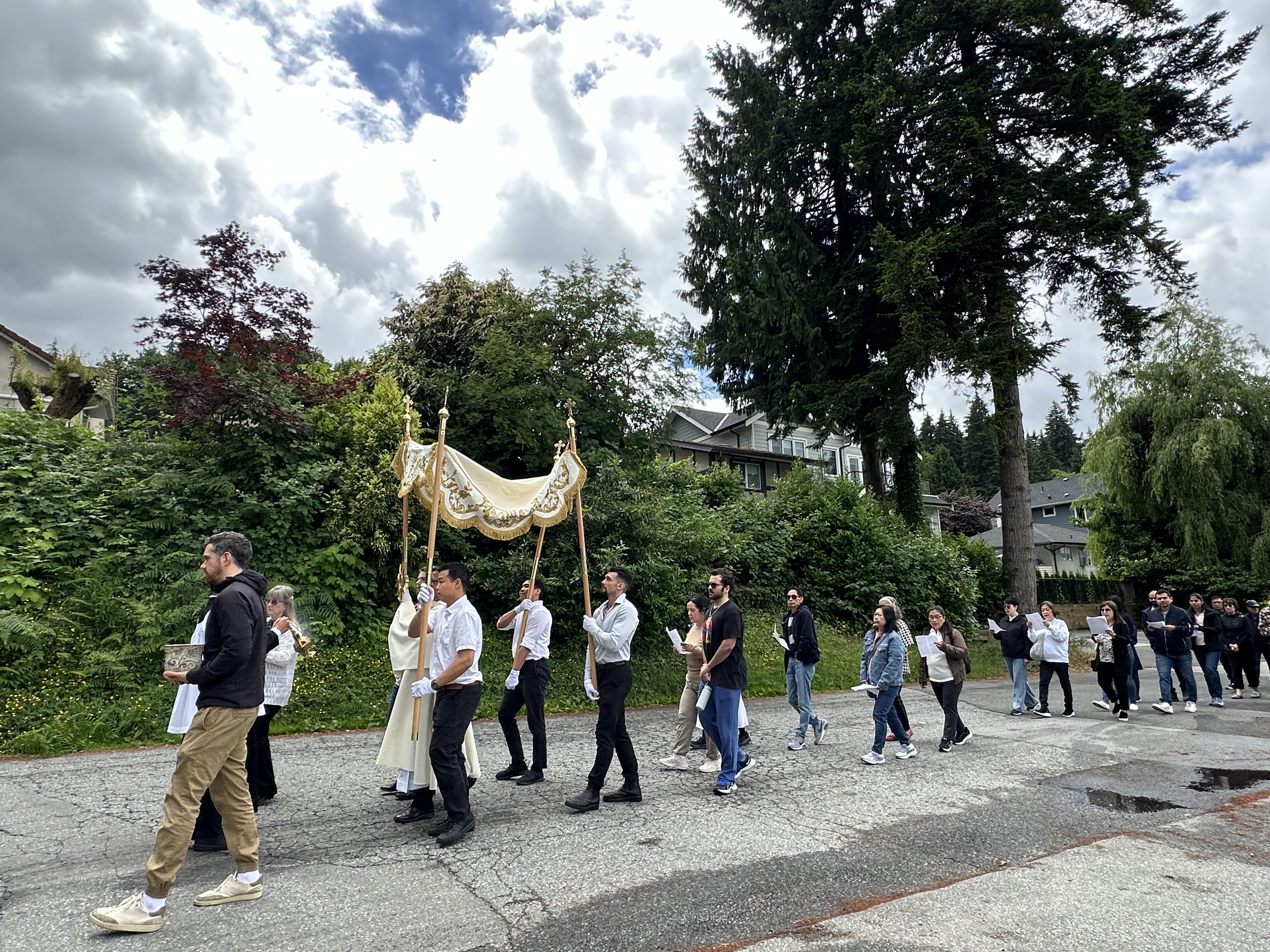 The Corpus Christi procession passing through a residential street in Port Moody