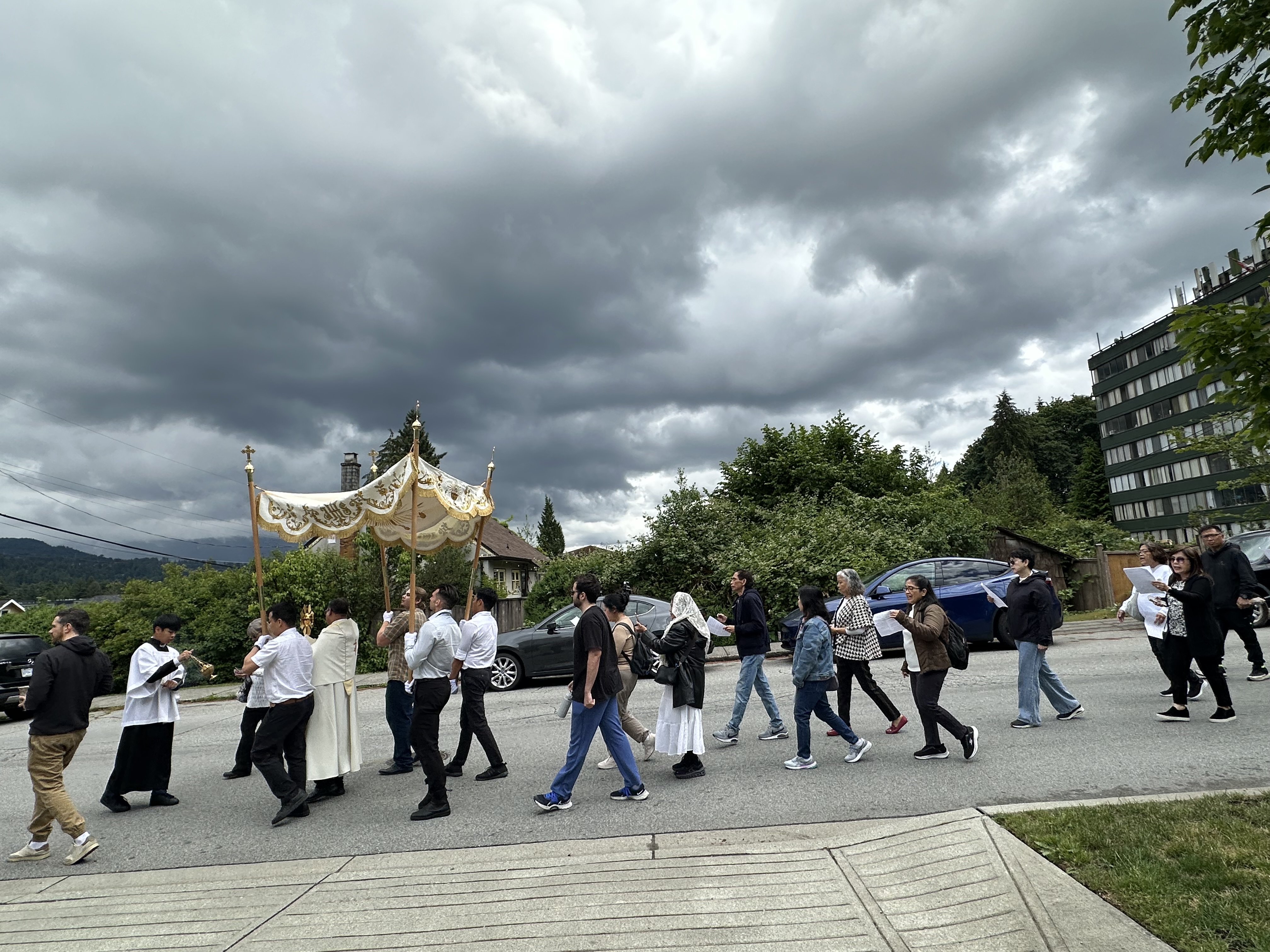 Parishioners walking and singing during the Corpus Christi procession