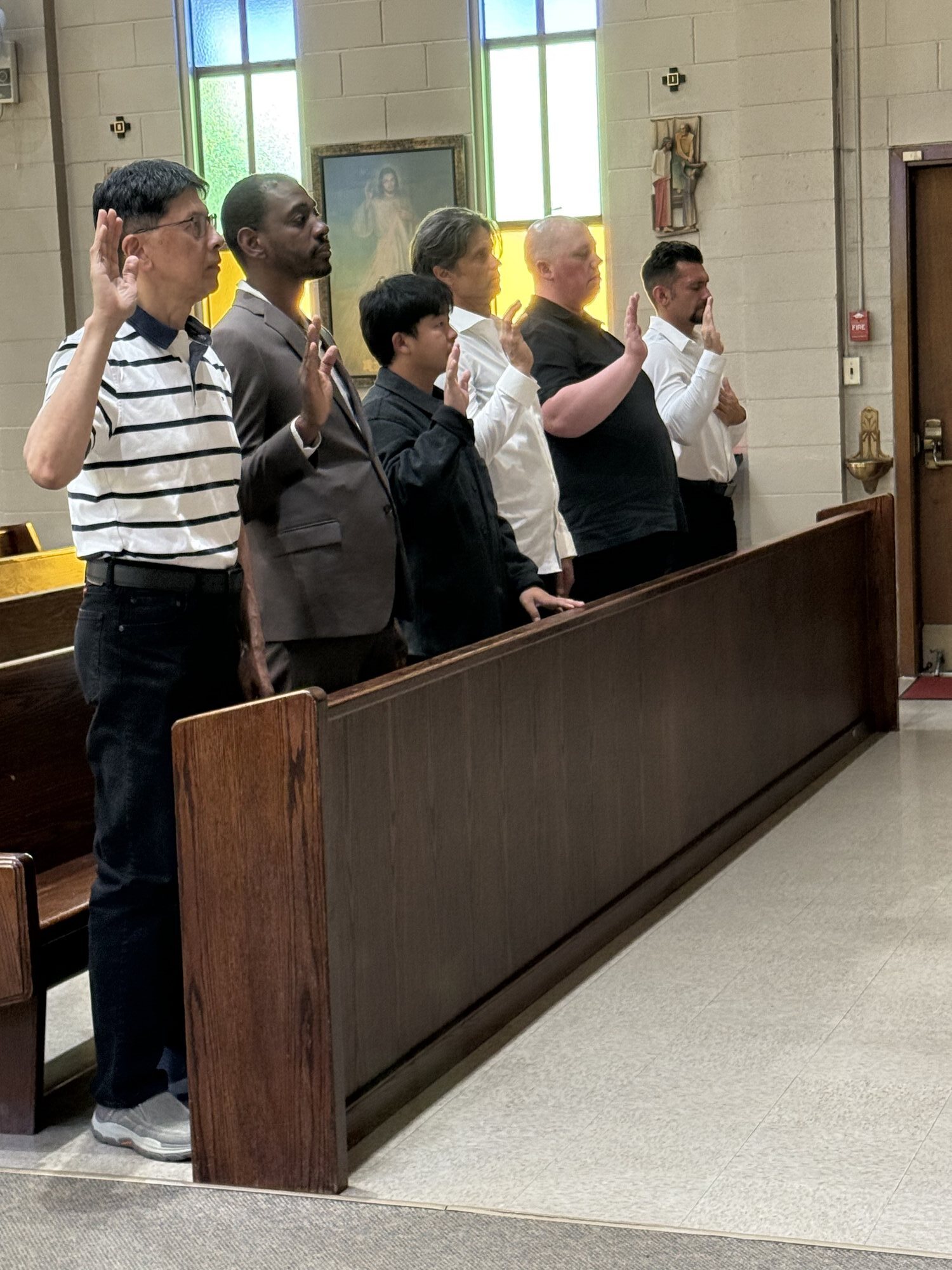 New Knights raising their right hands during the Exemplification