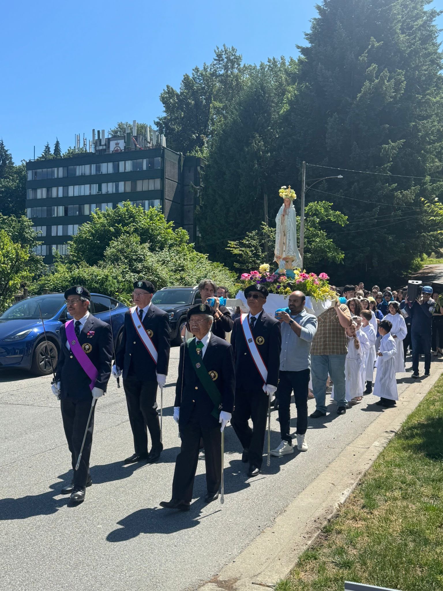 Knights of Columbus leading the Marian Procession with Mary's statue behind them