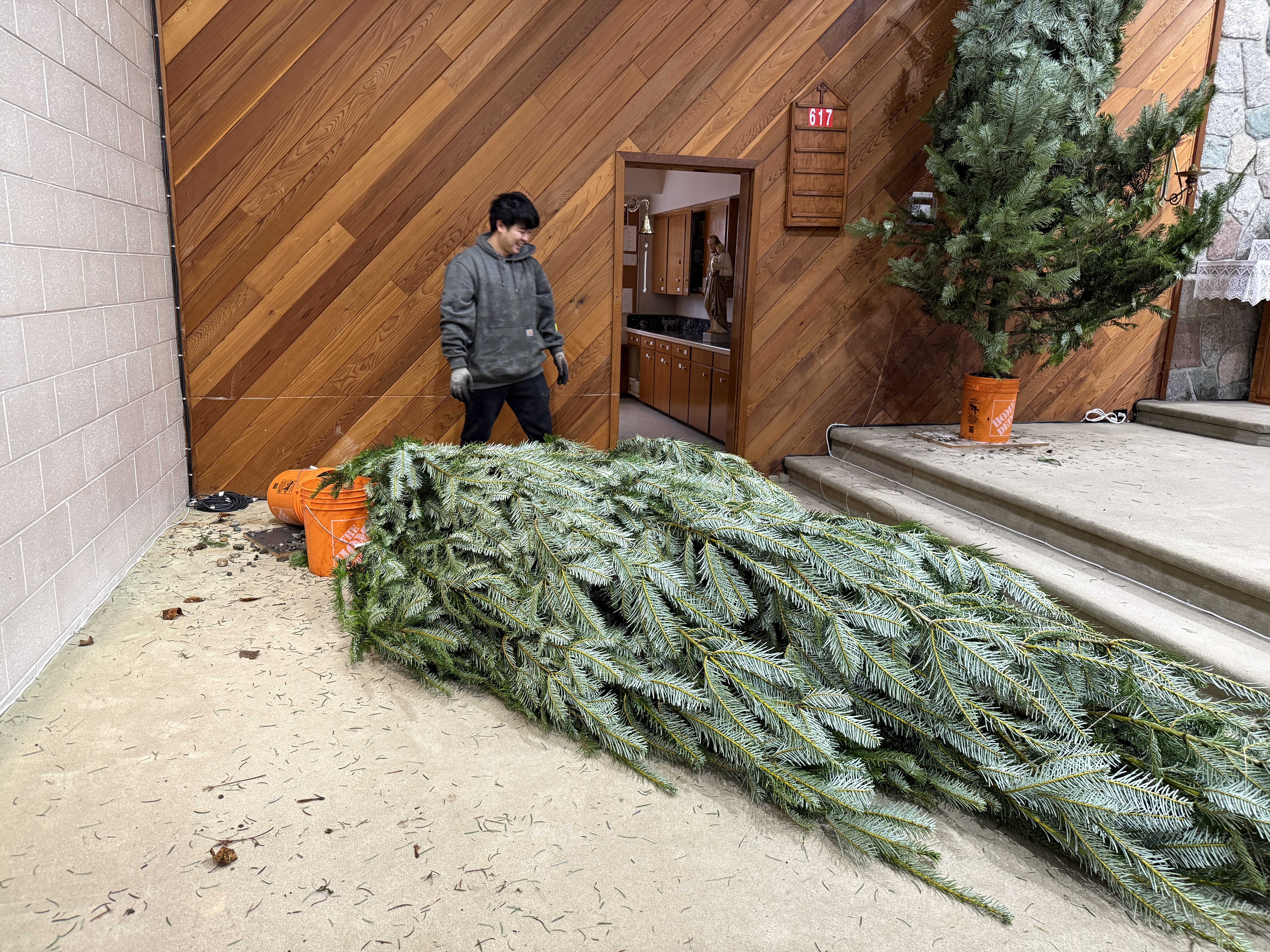 Steadying a tree as it comes upright in the church.