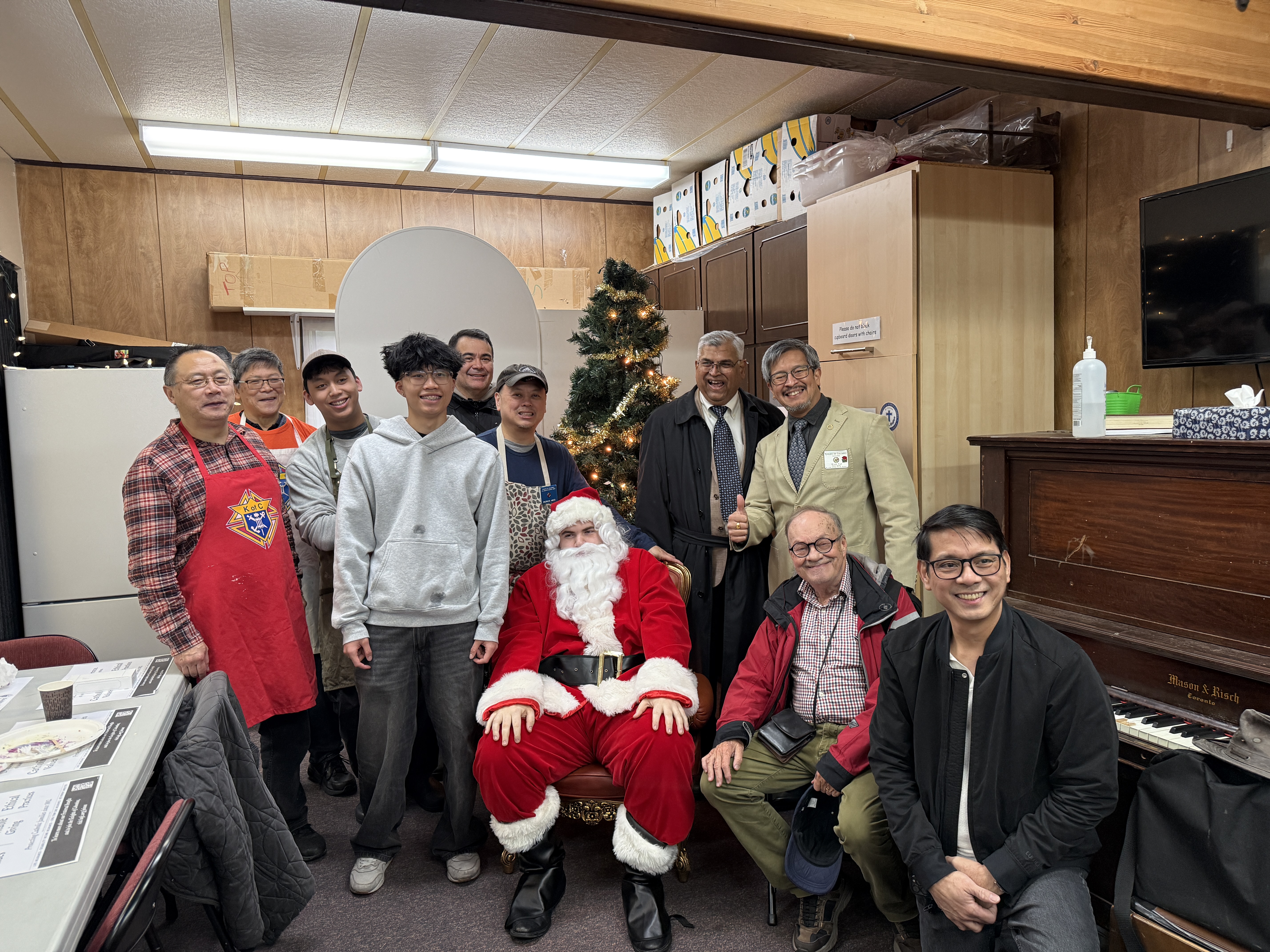 Knights and parish volunteers posing with Santa at the breakfast